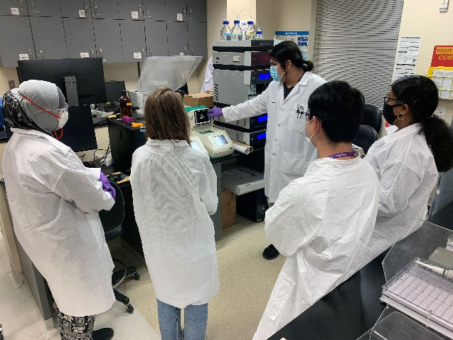 Fig. 2. Student technicians learning the functions of thermocycler equipment for PCR 