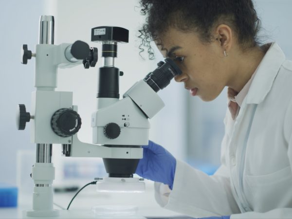 Use A Scanning Electron Microscope: NanoEducators Quarterly Forum _NOV Female Scientist Looking into Microscope _Micro Nano Technology