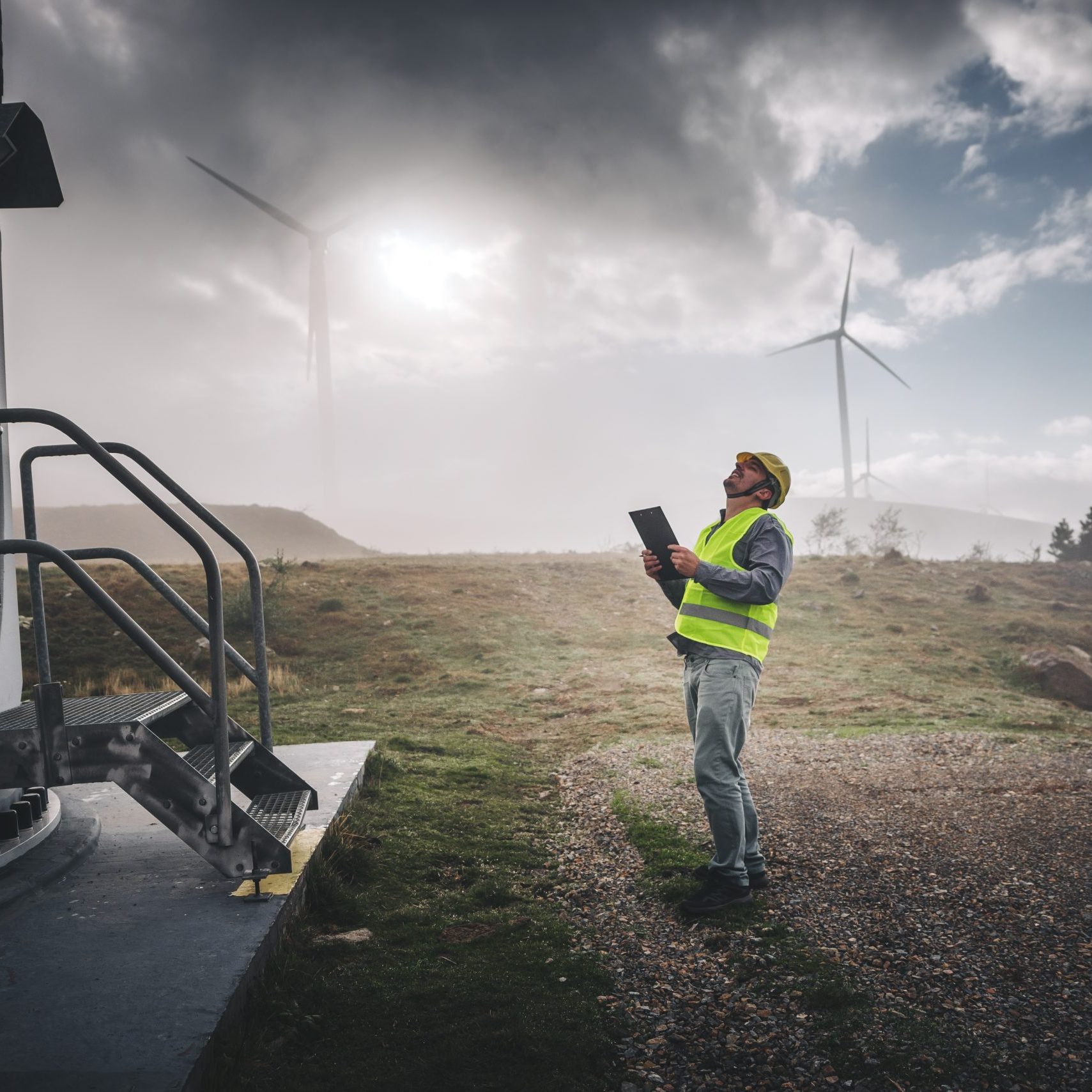 Young engineer man looking and checking wind turbines